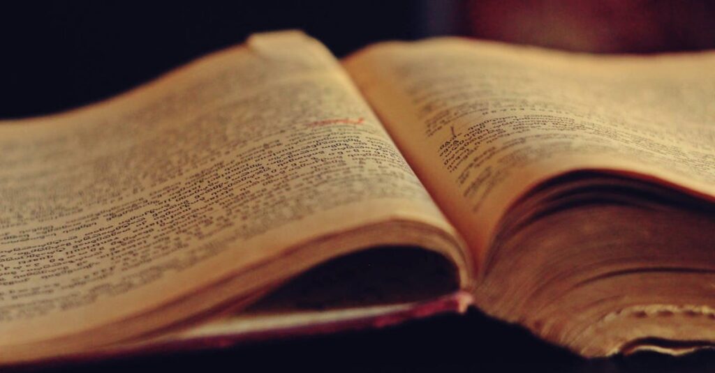 A vintage open book displaying aged, yellowed pages with faded text.